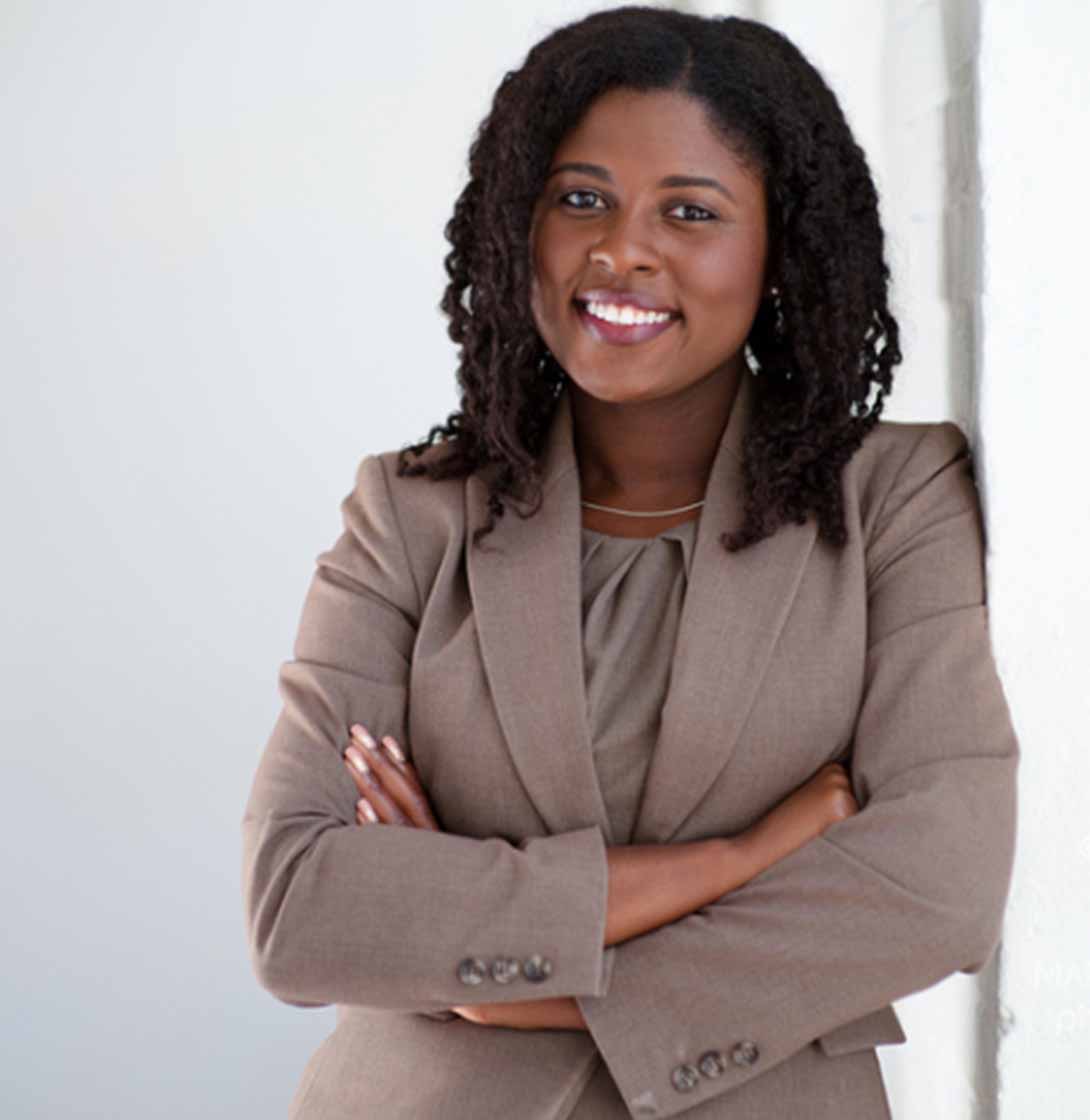 Image of LaSheena Williams Smiling and Leaning on a Wall